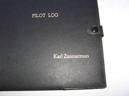 Personalised name embossing on black leather pilot log book cover